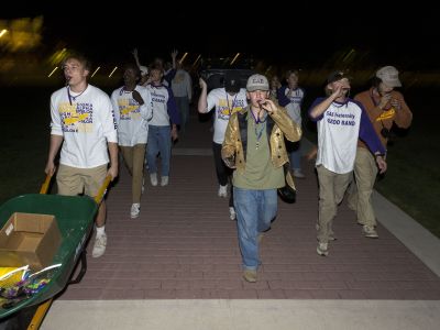Kazoo Band performs down the sidewalk by Main Hall