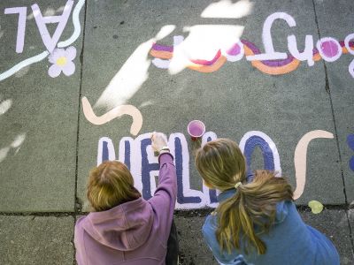 Two people painting on on the Hello Walk