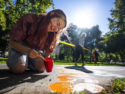Person painting on the Hello Walk