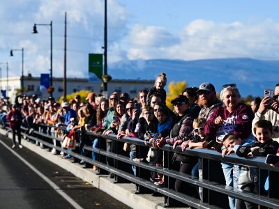 Crowd of people watches parade on Higgins Ave. bridge