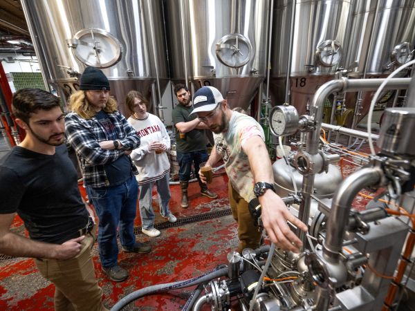 photo of students learning to brew the beer.