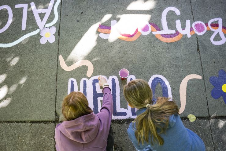 Two people painting on on the Hello Walk