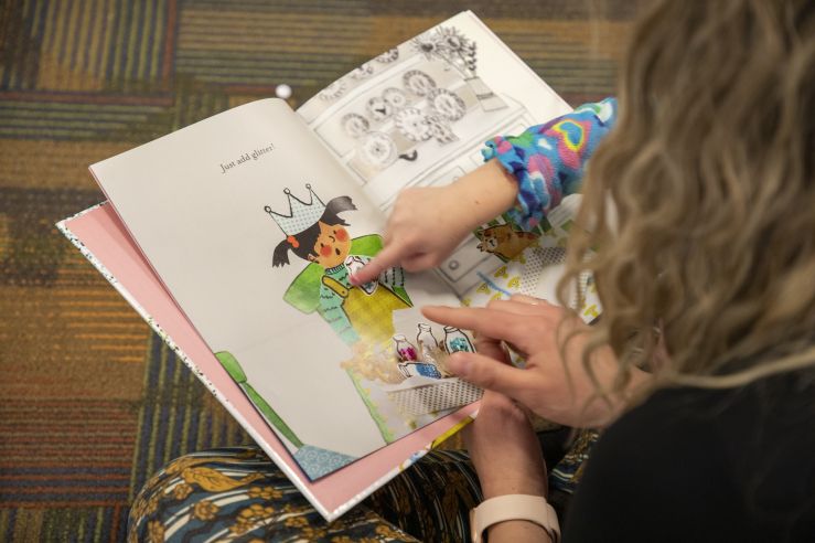 Photo of someone reading a children's book to a child