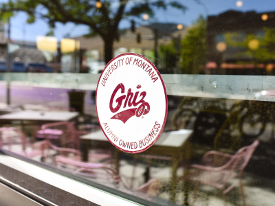 Business window with a Griz Owned cling featured on the front