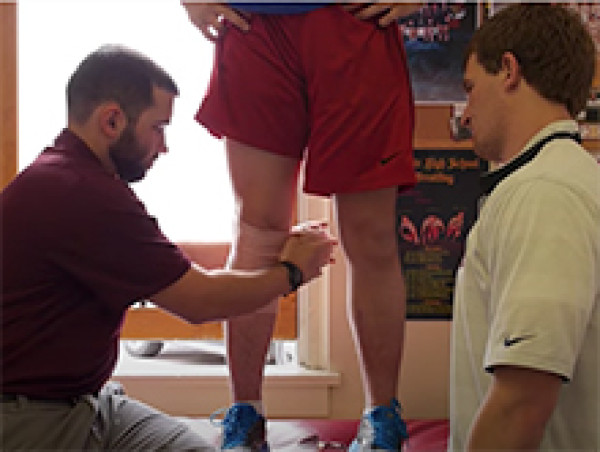 AT Student Wrapping Knee Injury