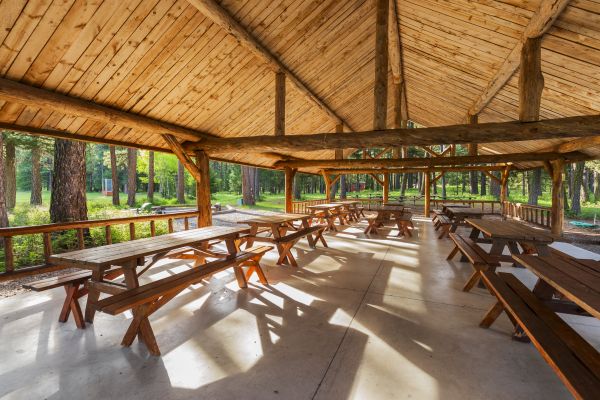 inside of a pavilion with picnic tables