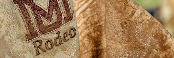�Թ��� Rodeo team logo on a weathered cowboy vest.