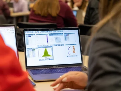 a student works a math equation on a laptop
