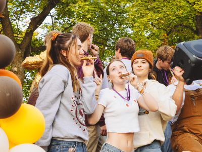 Girls blowing a kazoo