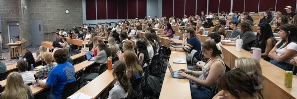 Students sit in a lecture hall on the first day of class