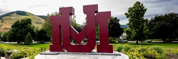 UM students gather in a formation of  U and an M letters