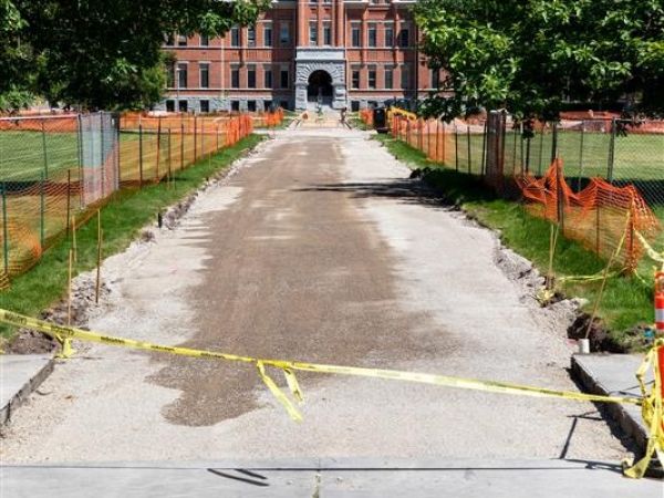 caution construction sign on fence