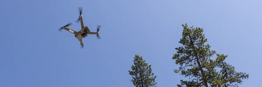 A droe flies above blue skies
