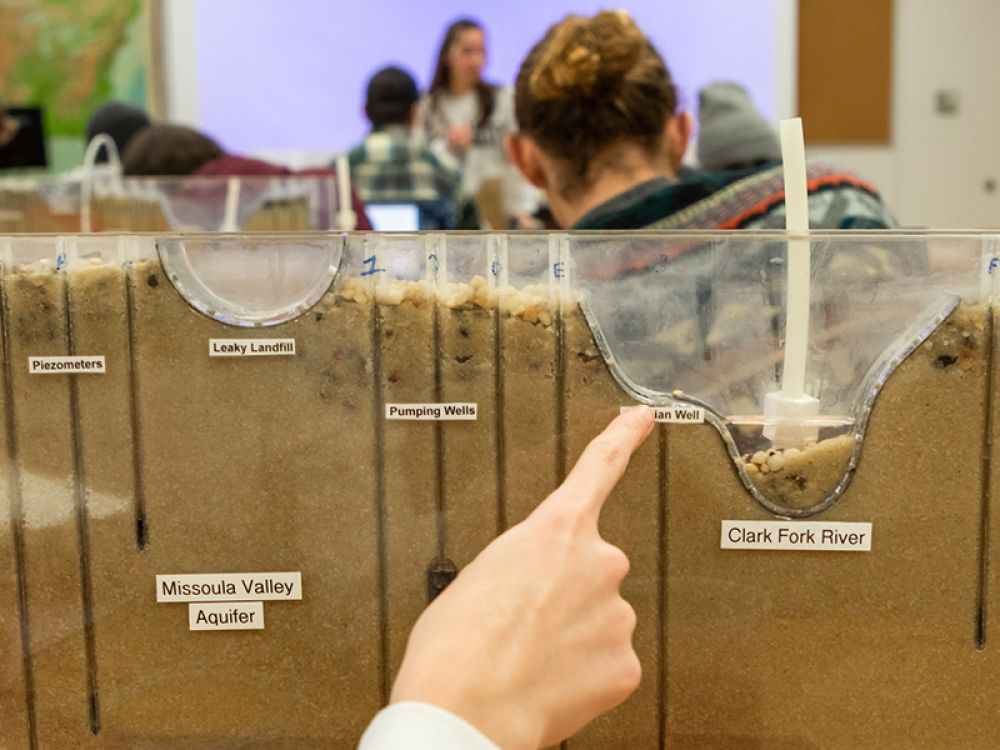A student points to a science experiment