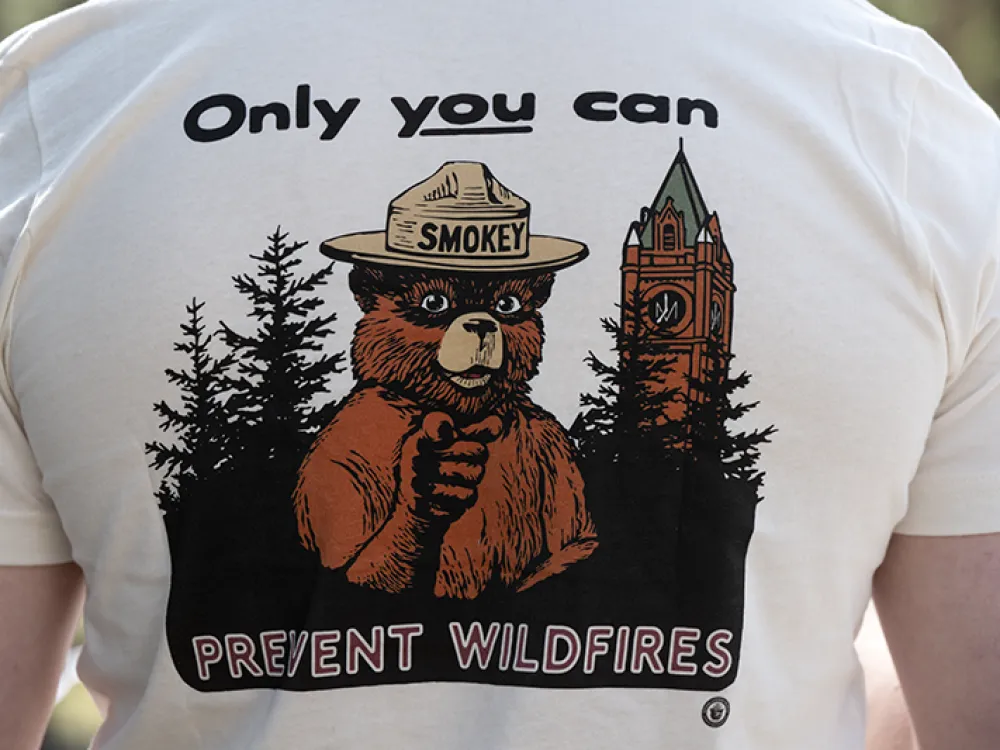 A T-shirt showcasing Smokey Bear next to UM's Main Hall