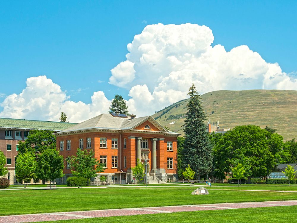 Jeannette Rankin Hall in summer with Mount Jumbo in the background