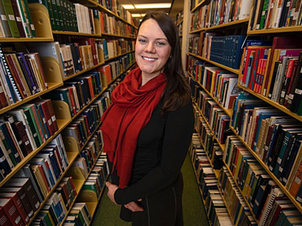 Looking into the lighted Mansfield Library Commons from the outside