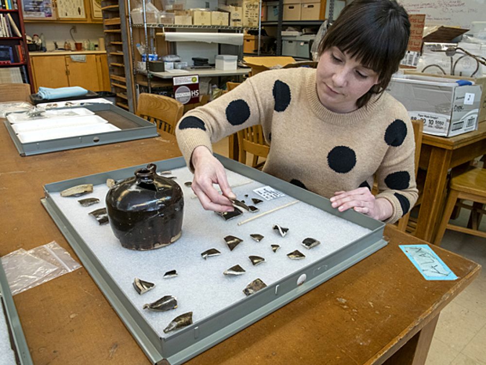 UM graduate student Kate Kolwicz works with fragments of Chinese utilitarian brownware