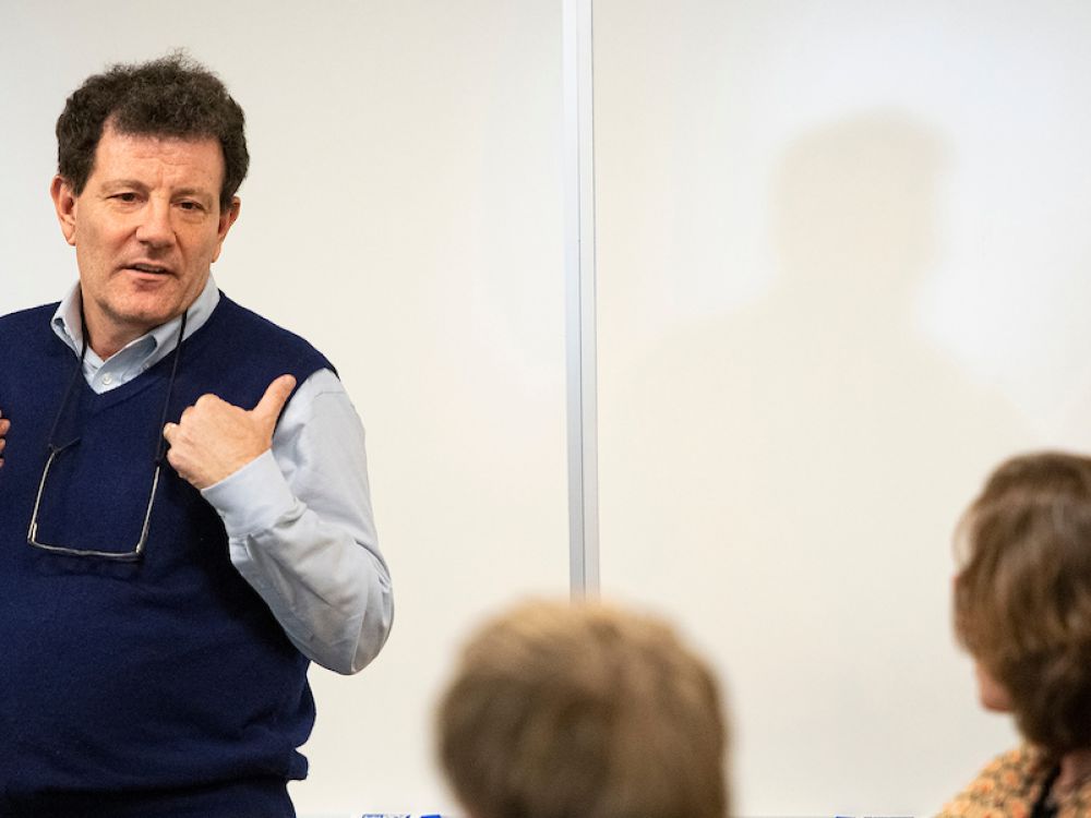Journalist Nicholas Kristof lectures in the classroom