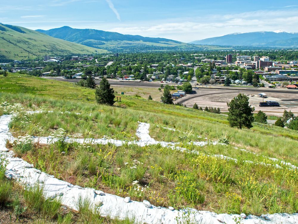 A large peace sign on the ground overlooks Missoula from the North Hills