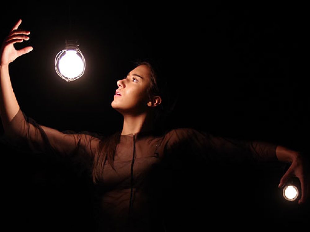 An artistic picture of a dancer with light bulbs