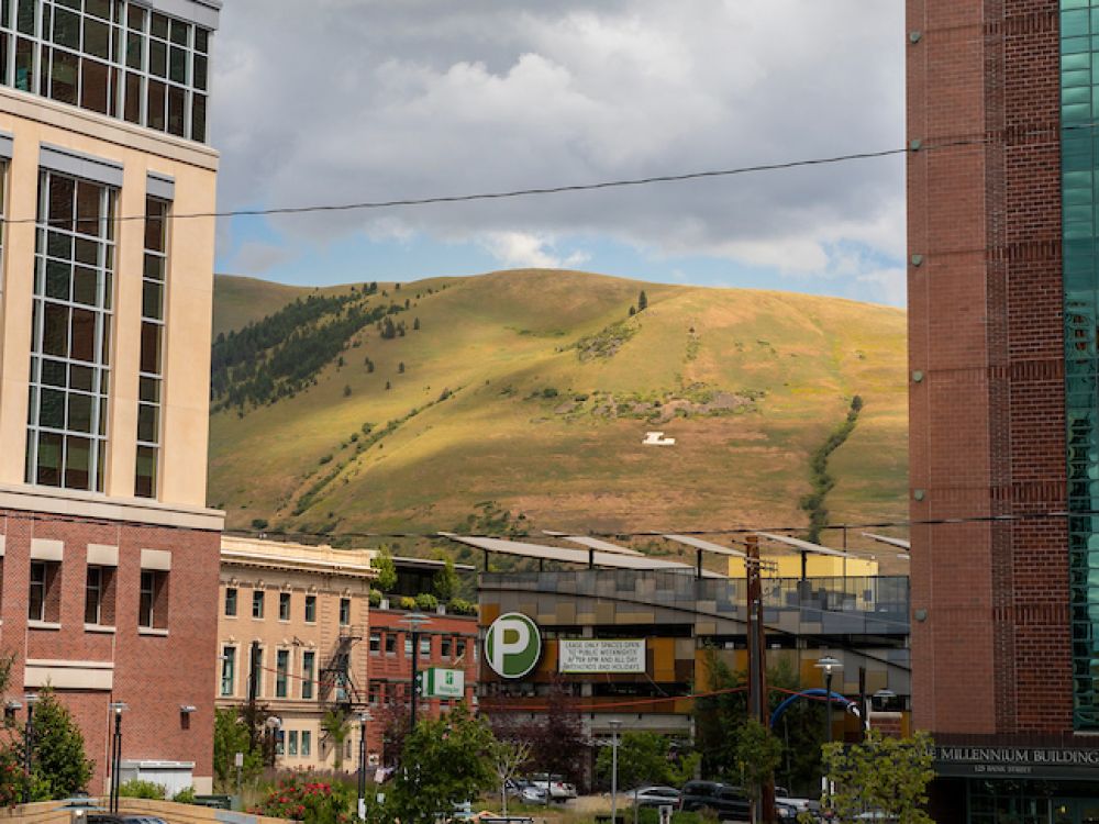 Mount Jumbo as seen through high rise buildings in downtown Missoula