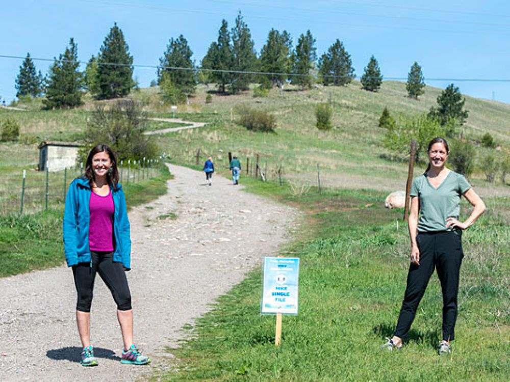 UM researchers Jennifer Thomsen and Libby Metcalf (right) stand at the Missoula trailhead