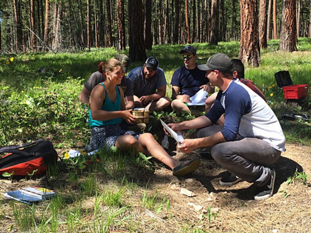 UM students attend class in a forest.