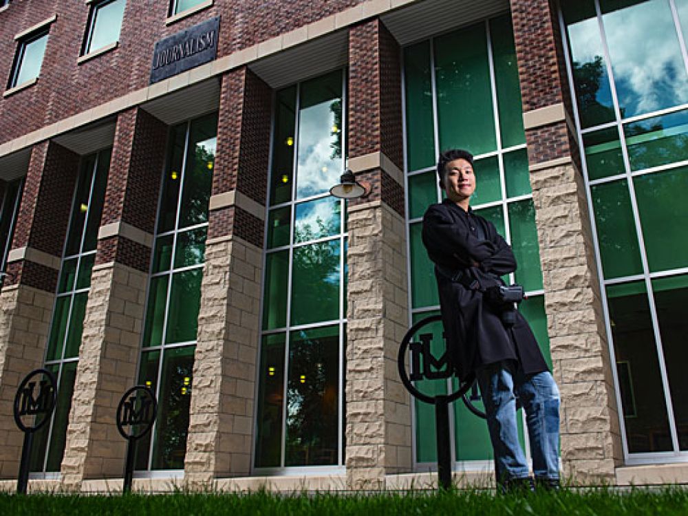 Jiakai “JK” Lou, a student in UM's School of Journalism, poses outside Don Anderson Hall.