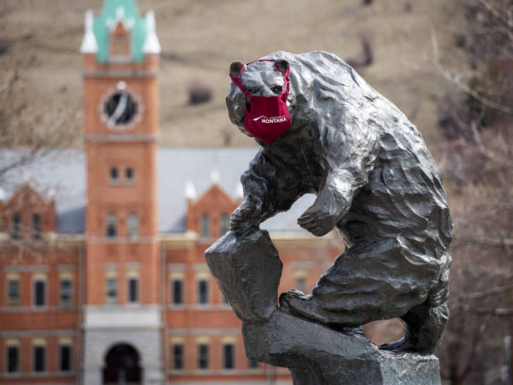 A picture of the Grizzly Bear statue on the Oval wearing a mask.