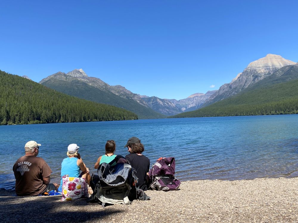 A family enjoys a lake view in Glacier National Park.