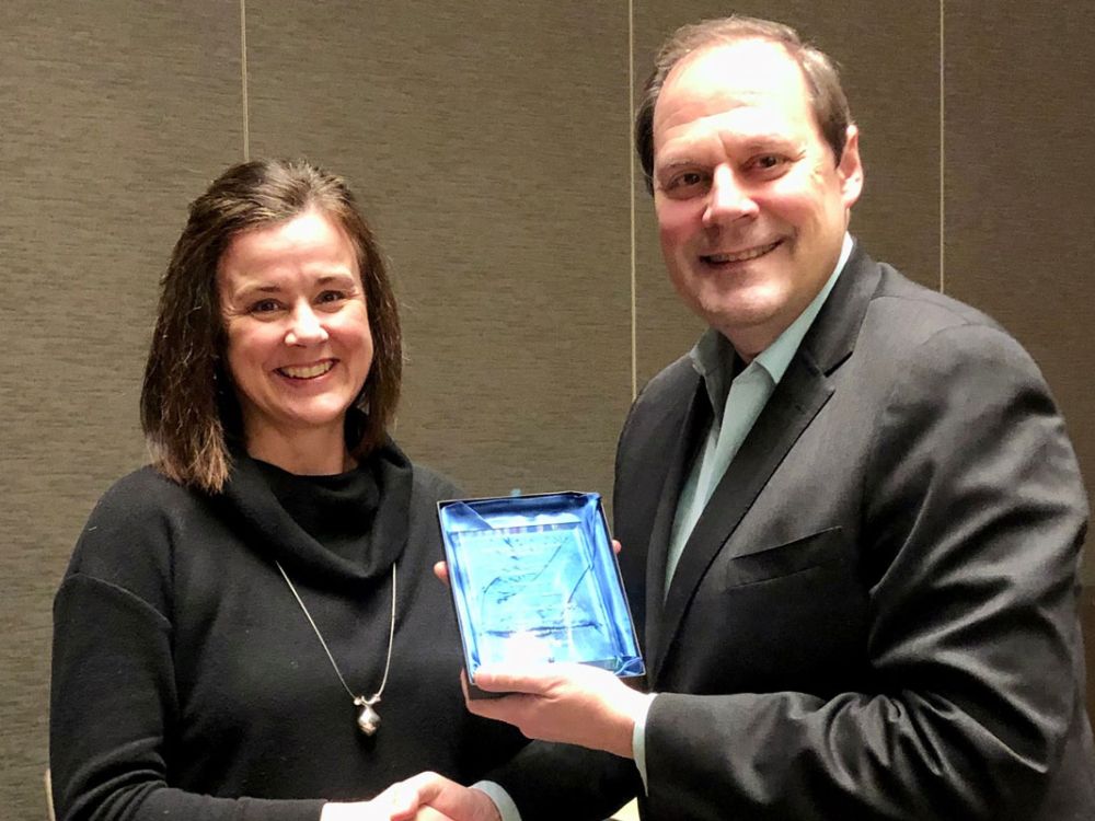 UM law Assistant Professor Anna Conley receives the 2023 Mark Tushnet Prize in Comparative Law from Mark Wojcik of the Association of American Law Schools.