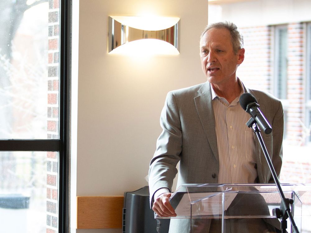A picture of Tim Nichols speaking at a podium.