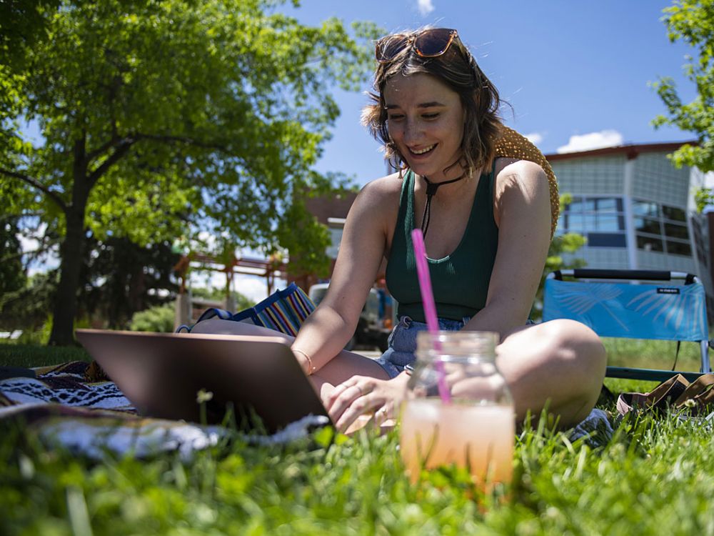 UM student Siena Cysewski studies with a laptop on the UM Oval.