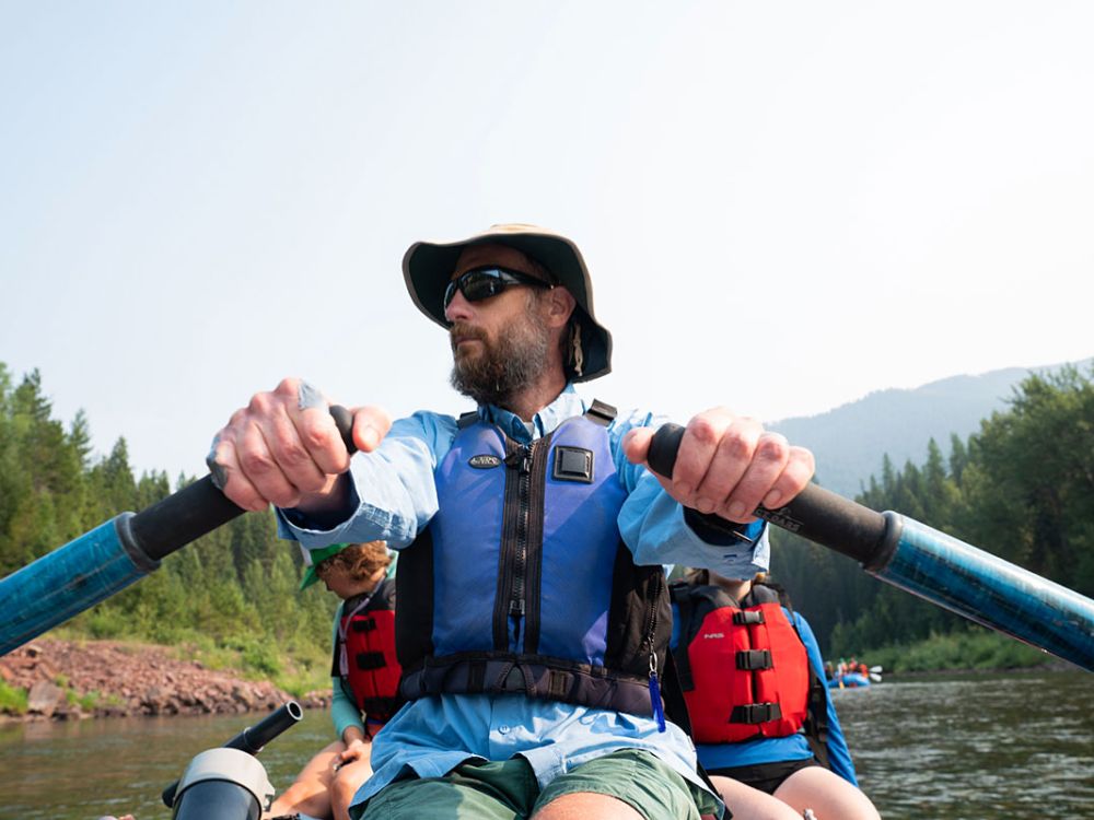 A picture of researcher Bob Hall rowing in a raft.