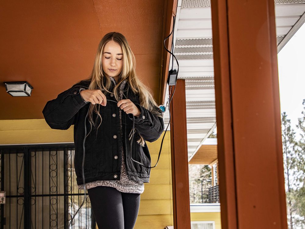 Photo of Kristen Cram installing a monitor