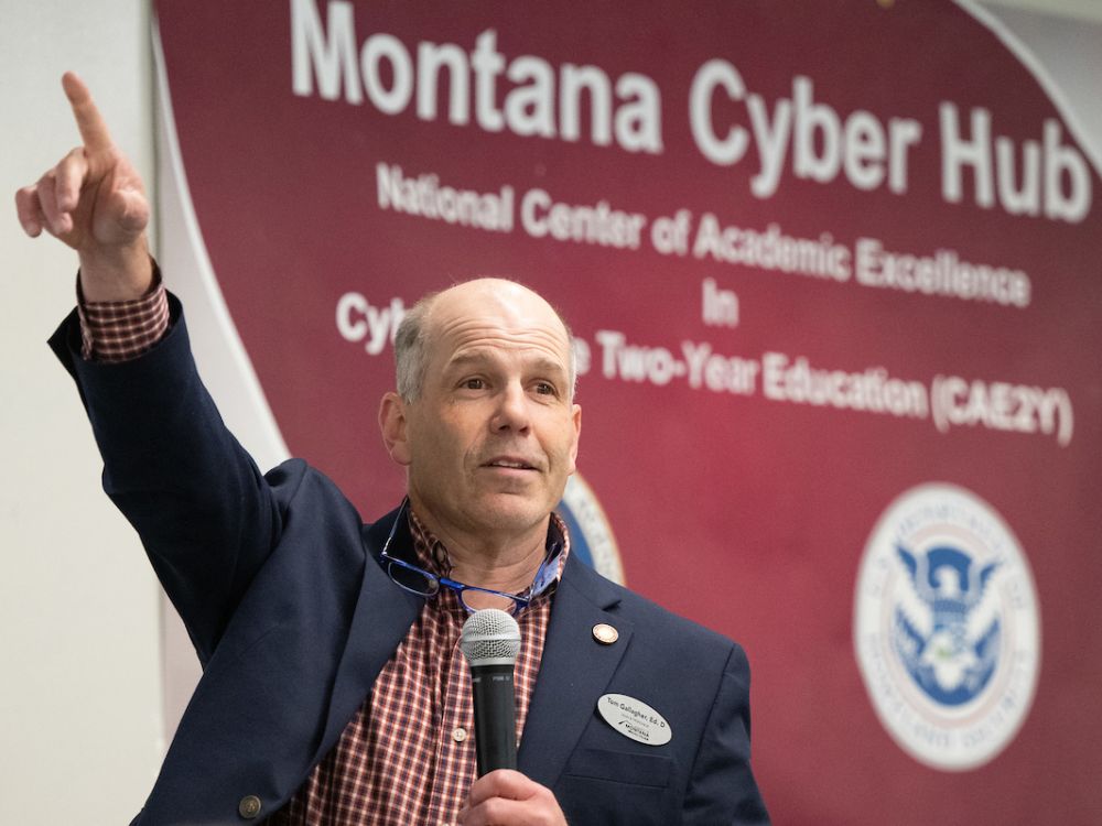Missoula College Dean Tom Gallagher points to a room full of people