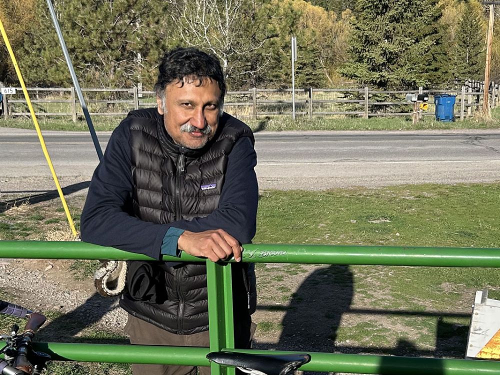 A picture of Bharath Sriraman leaning on a fence.