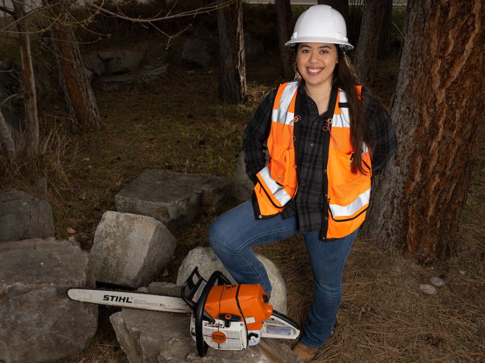 Lexi Smith posses with a chainsaw