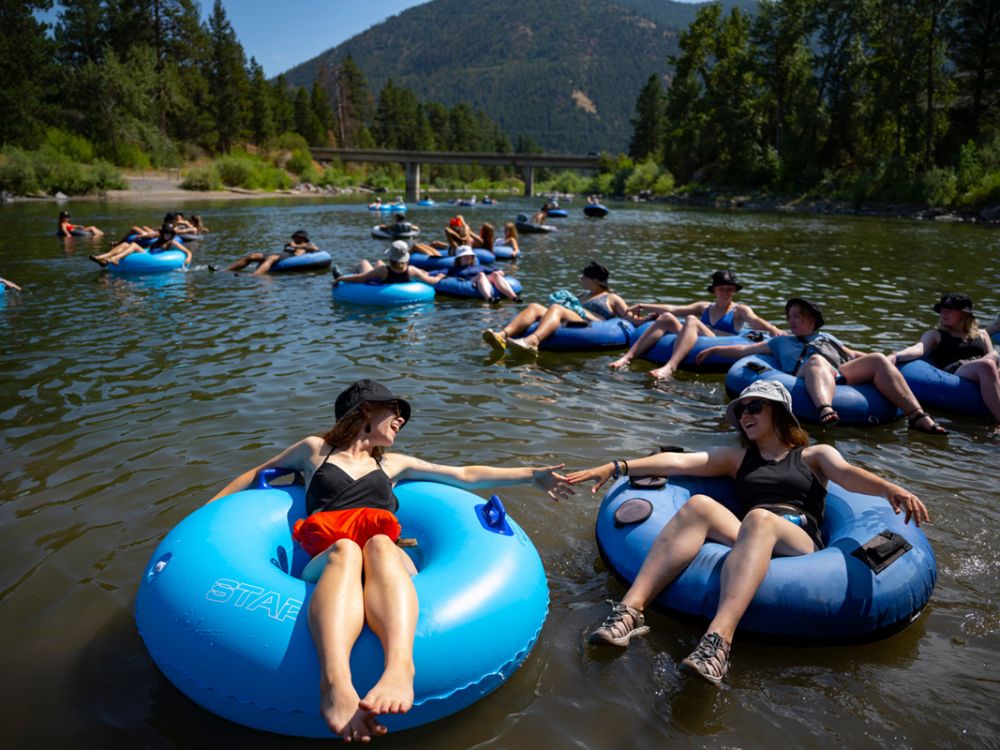 An image of people on tubes floating the Clark Fork River. 