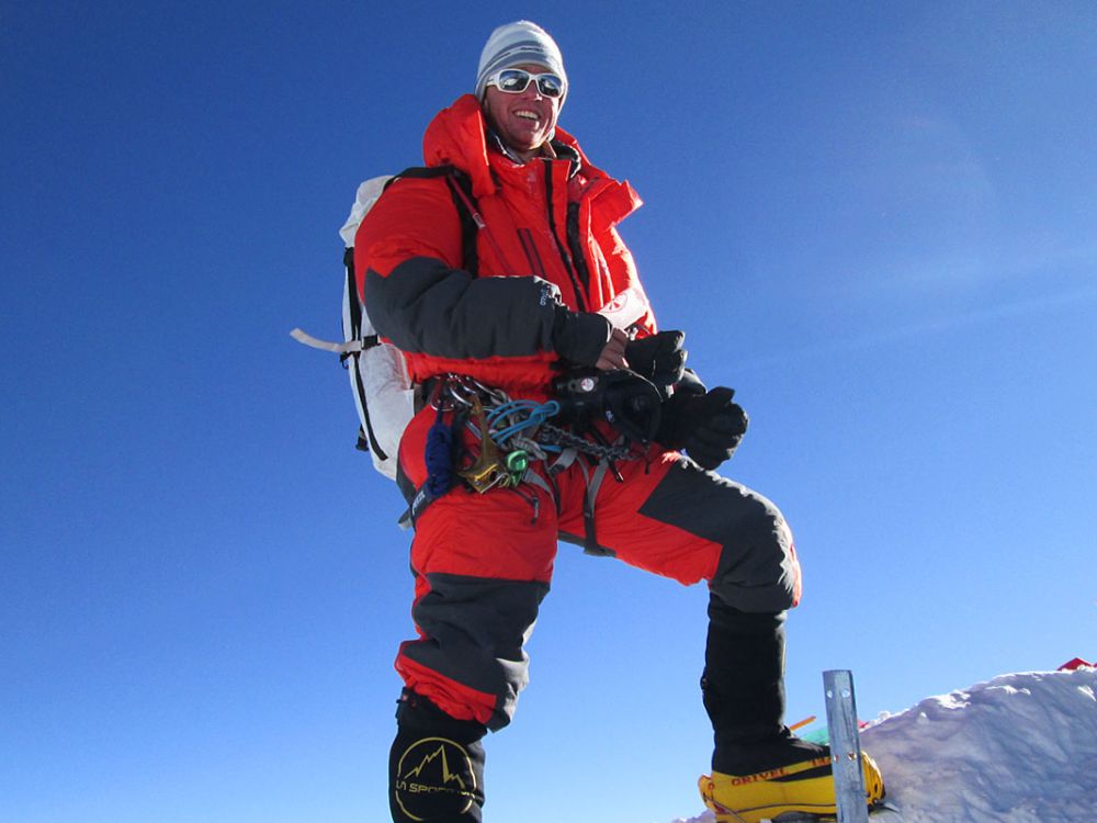 Walter Hailes stands atop Mount Everest.