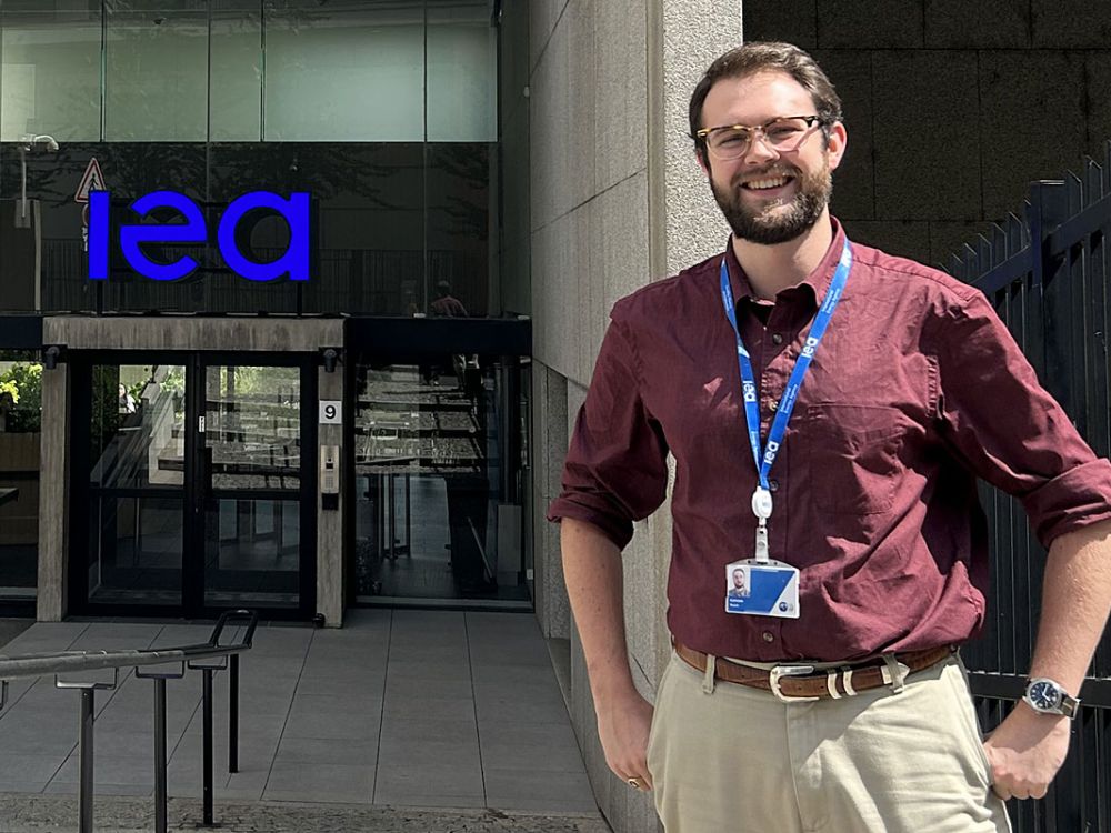 Photo of Noah Web standing in front of the IEA headquarters
