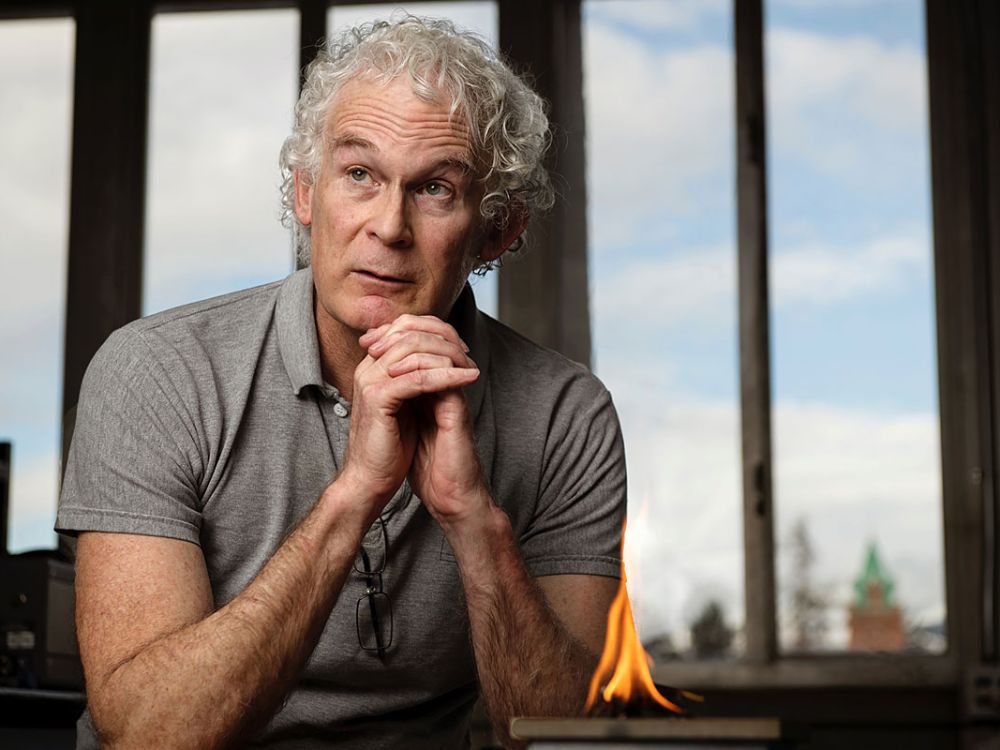 A picture of Bob Yokelson with his hands crossed over fire.