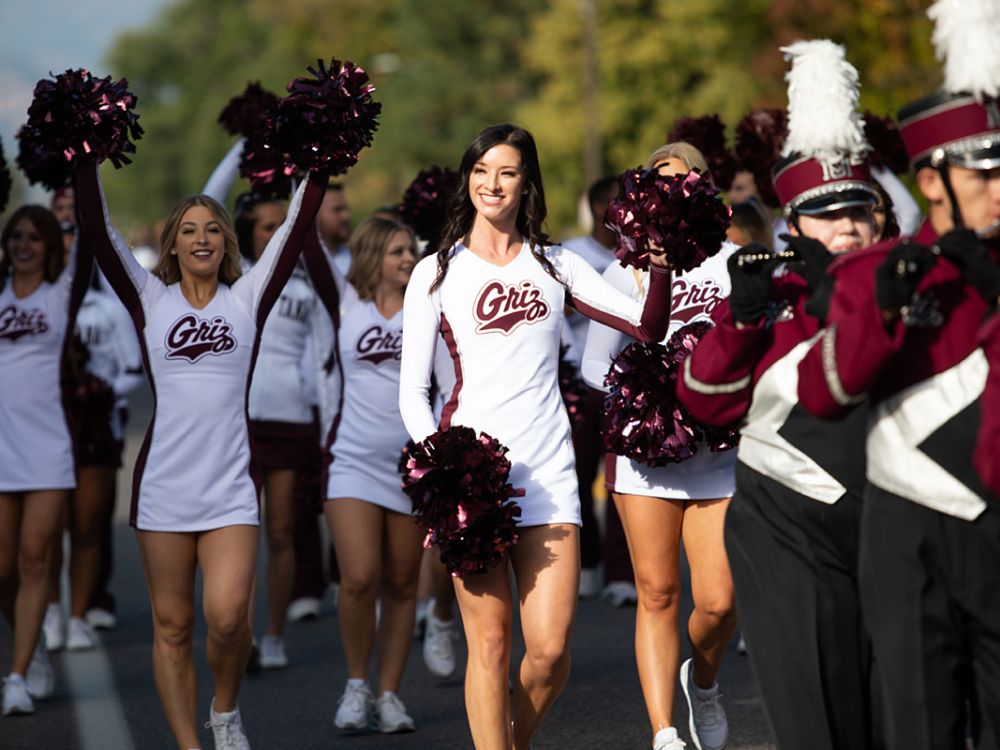 Cheerleaders walk in the UM Homecoming Parade.