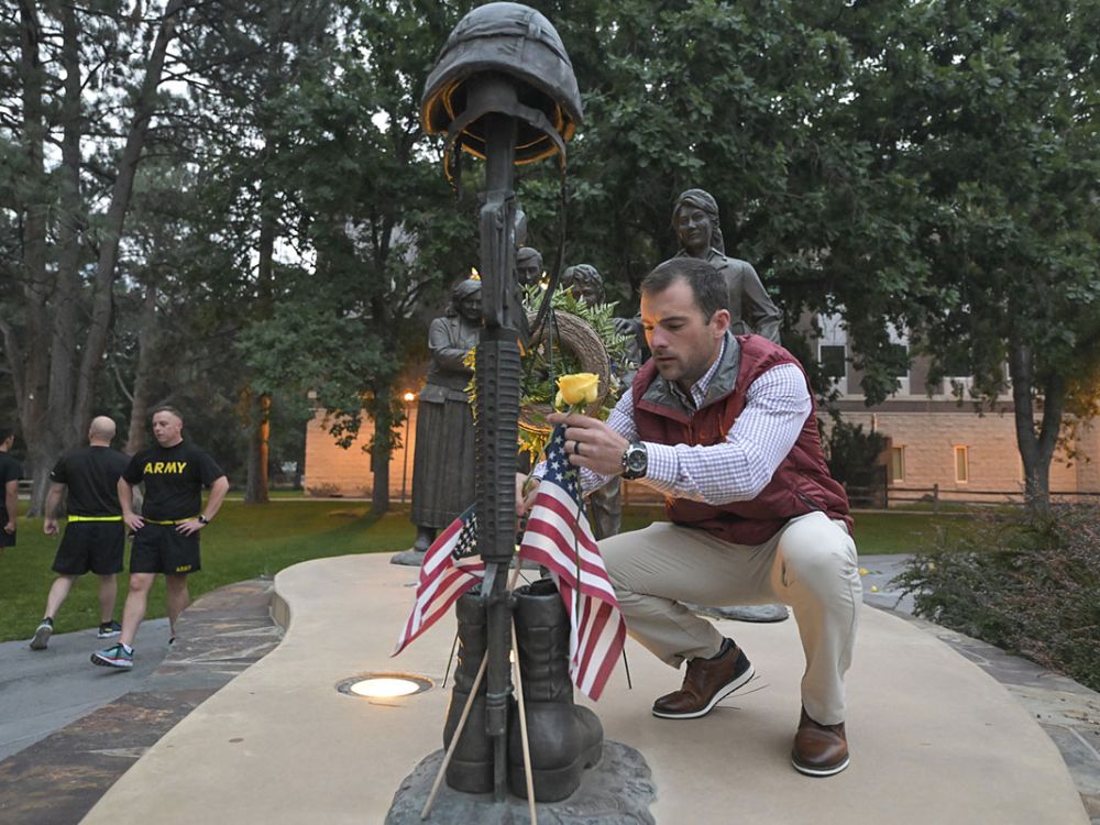 Patrick Beckwith, director of UM’s Military and Veterans Services Office, decorates the Fallen Soldier Memorial on campus in fall 2022. 