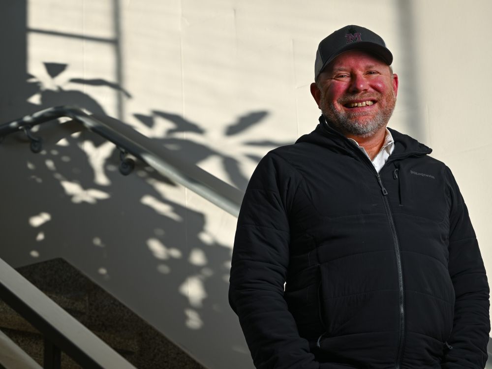 Dr. Cory Cleveland stands for a portrait