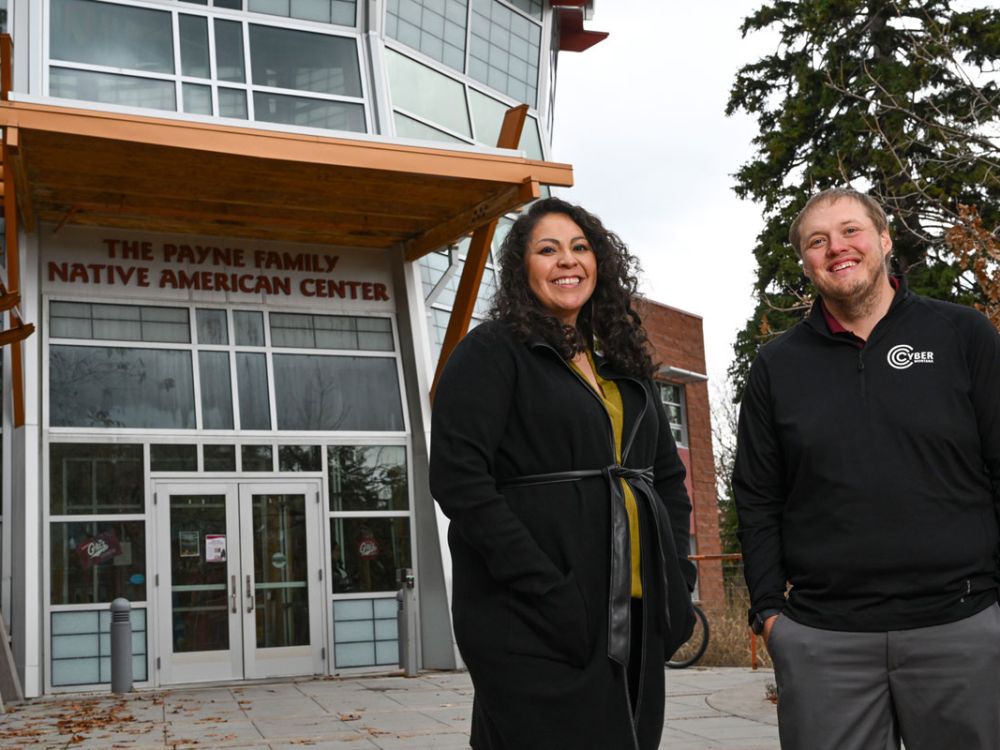 Karla Bird, UM tribal outreach specialist, and Zach Rossmiller, UM chief information officer, pose before the Payne Family Native American Center.