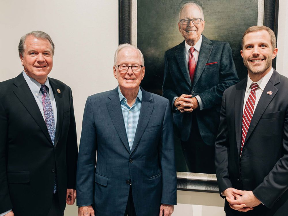 Terry Payne poses with Commissioner of Higher Education Clayton Christian and UM President Seth Bodnar.