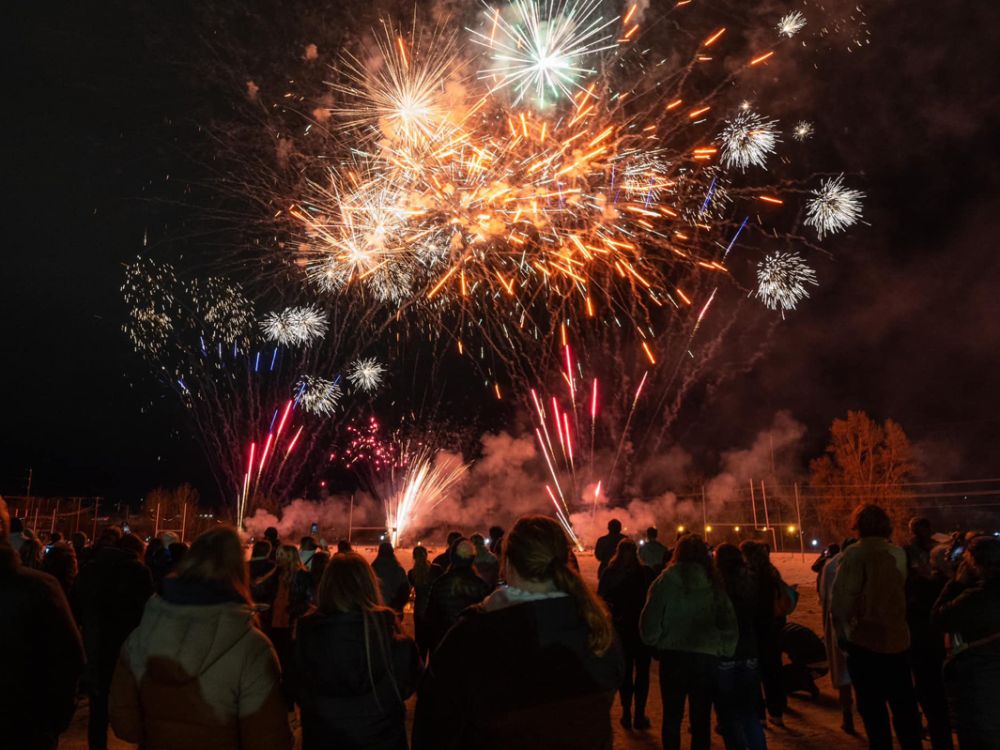 A photo of UM students watching fireworks. 