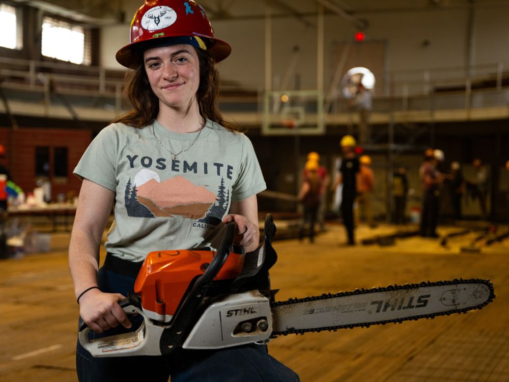 An image of Jaiden Stansberry holding a chainsaw. 